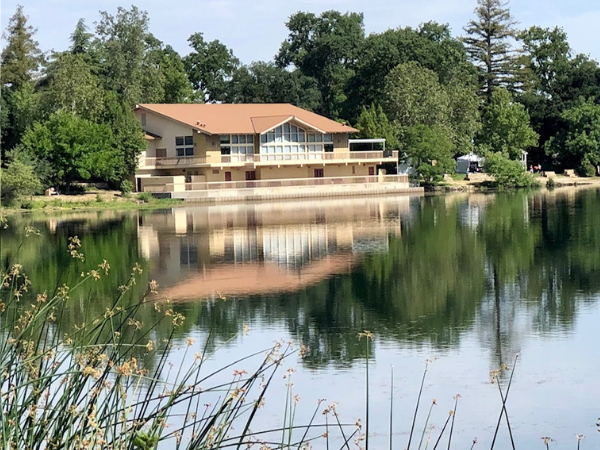 Image of the Pavilion on the Lake building with lake in the foreground.