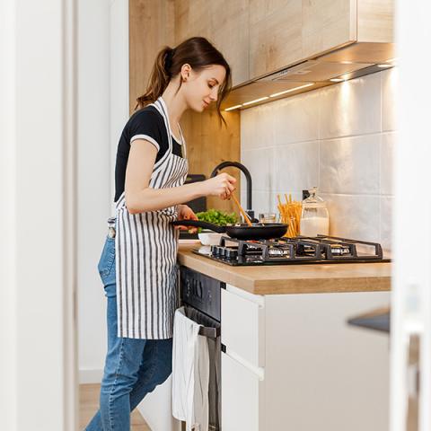 Woman cooking on gas stovetop