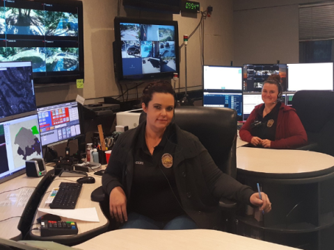 Two dispatchers at their workstations.