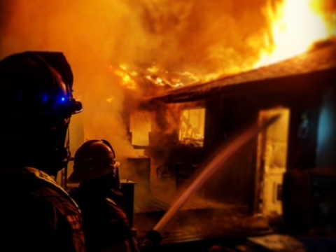 Photo of firefighter on scene at a structure fire.