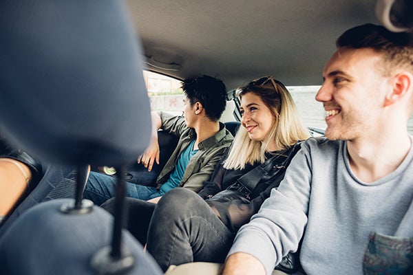 People sharing  a ride in a car