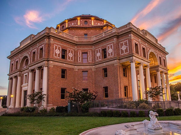 Image of City Hall with a colorful sunset.