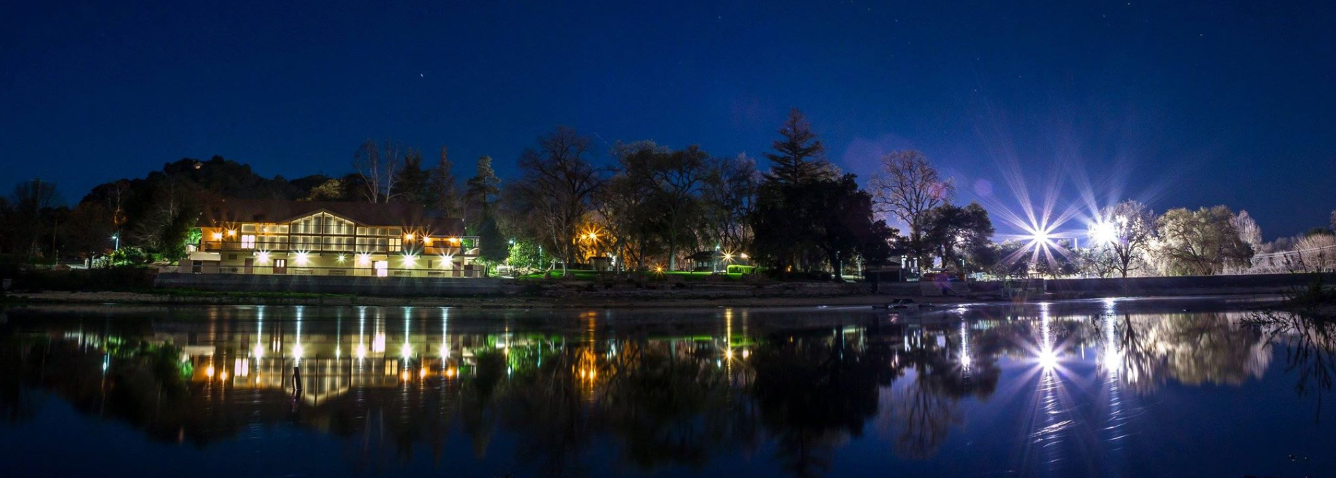 Night shot of the Pavilion on the Lake with vibrant light reflections on the Atascadero Lake.  Photo courtesy of Luke Phillips