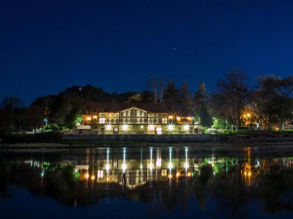 Night shot of the Pavilion on the Lake with vibrant light reflections on the Atascadero Lake.  Photo courtesy of Luke Phillips