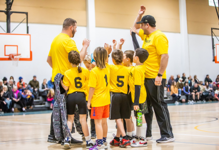 Image of young basketball players with their coaches.