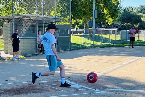 Adults playing kickball