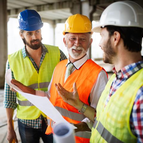 Three contractors speaking on the job site