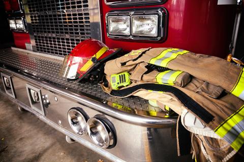 Fire gear on the bumper of a fire truck