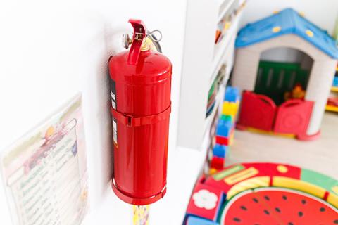 Fire extinguisher on a wall in a classroom