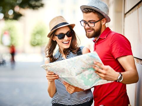 Tourist couple looking at a map