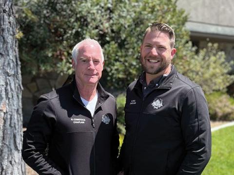 Photo of Chaplain Comstock and Chaplain Hall in front of the Police Station.