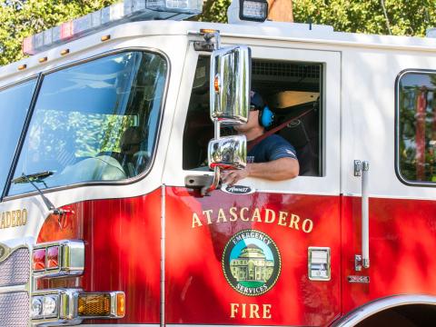 Image of an Atascadero Fire Department truck and driver.