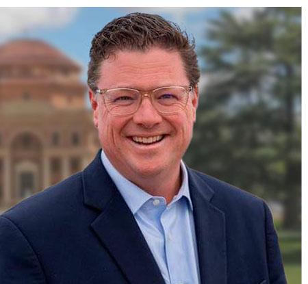 Portrait of City Manager Jim Lewis in front of City Hall.