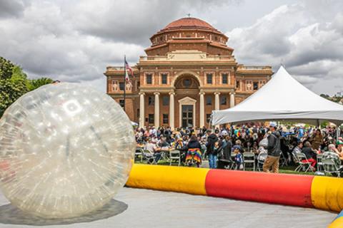 Photo of event happening in Sunken Gardens with Historic City Hall in the background.