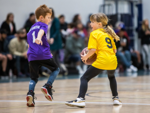 Children in action during a youth basketball game.