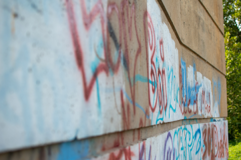 Image of a wall marked with graffiti.