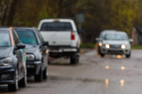 Images of cars on a residential road.