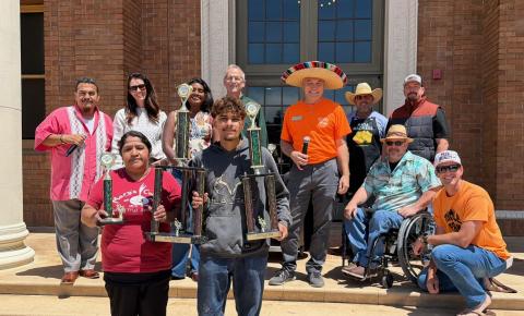 Group photo at the 2026 Tamale Festival showing the Best Overall Tamale winners, Mary’s Cuisine Catering from San Luis Obispo, standing on the steps of Atascadero City Hall and holding their trophies, with event judges posed behind them.