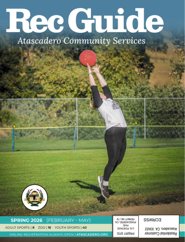 Cover of the City of Atascadero's 2026 Recreation Guide showing a person jumping straight up with arms and fingers extended to catch a red kickball.