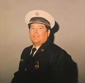 Portrait of former City of Atascadero Fire Chief Michael Paul McCain wearing a formal uniform against a neutral background.